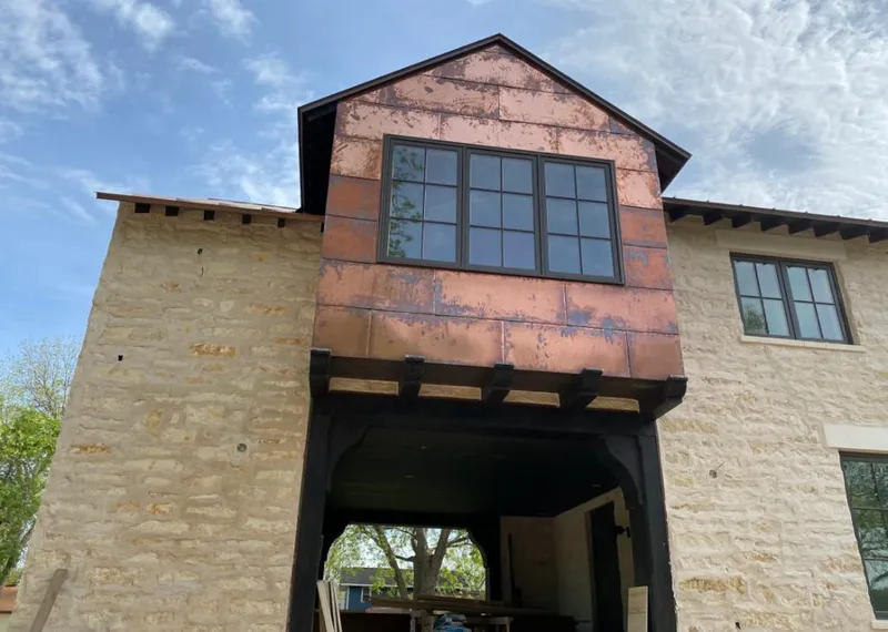 Copper metal panel facade on a stone building for Skylight Installation in Manteno